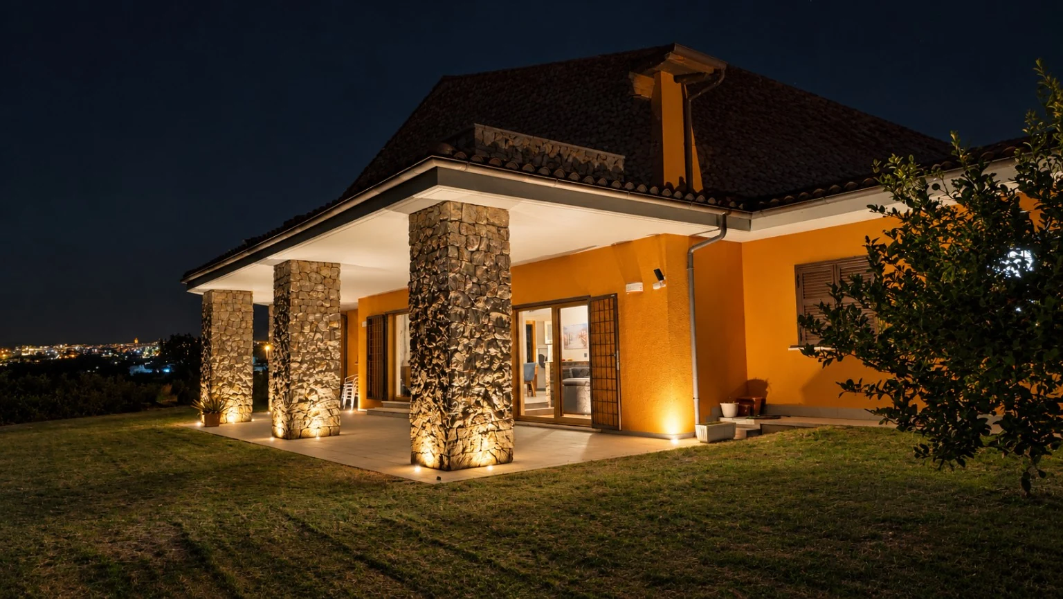 The stone portico illuminated at night